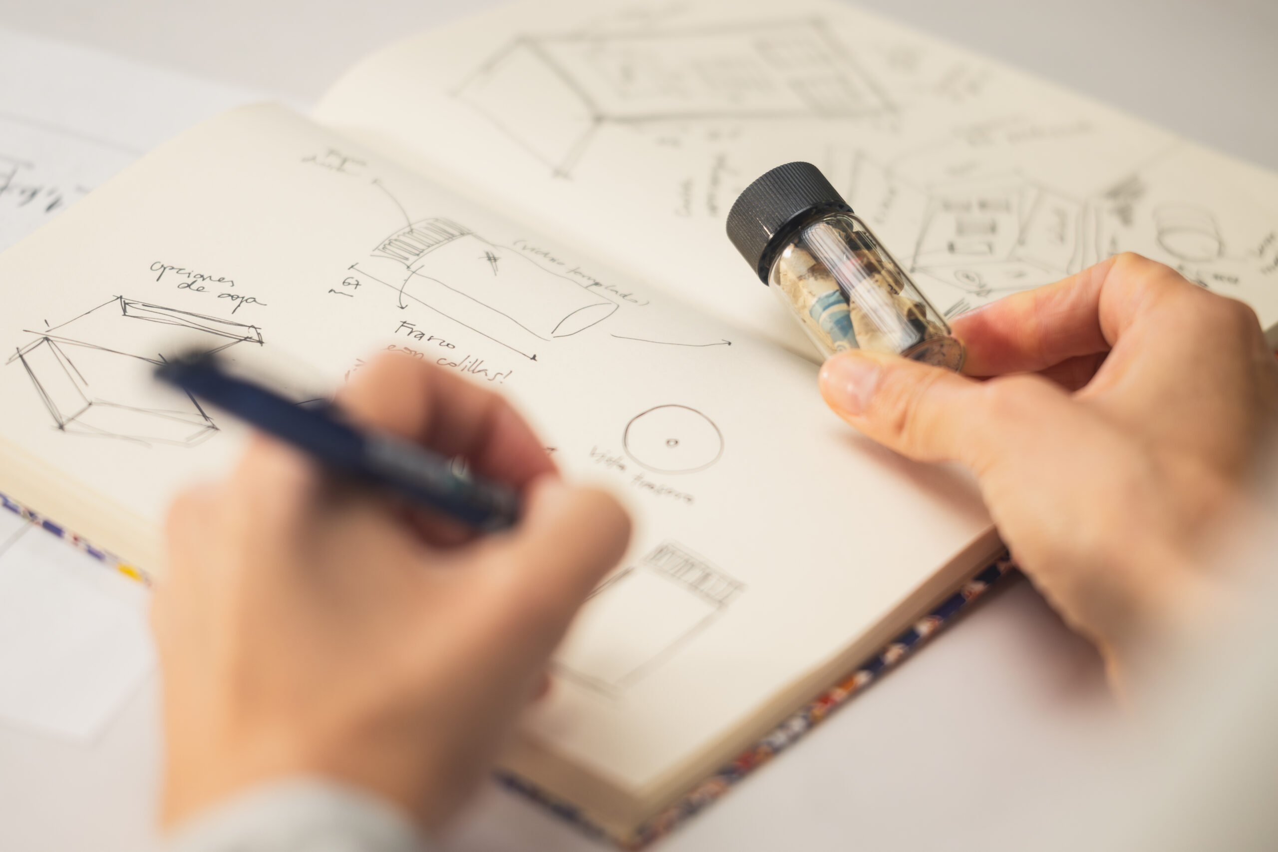 Celion - hand with cigarette waste and a notebook with ideas