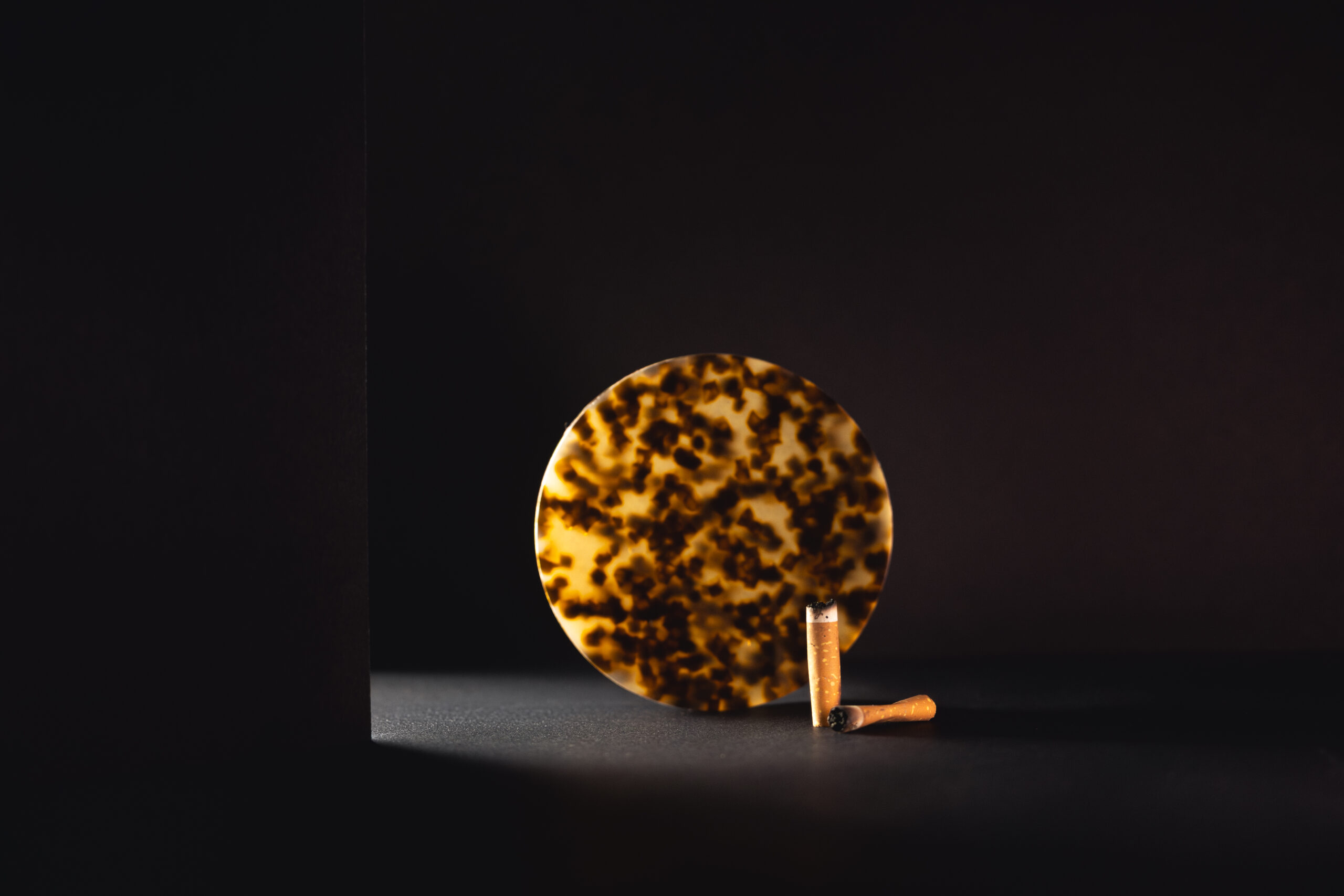 Celion plate with cigarette butts next to it